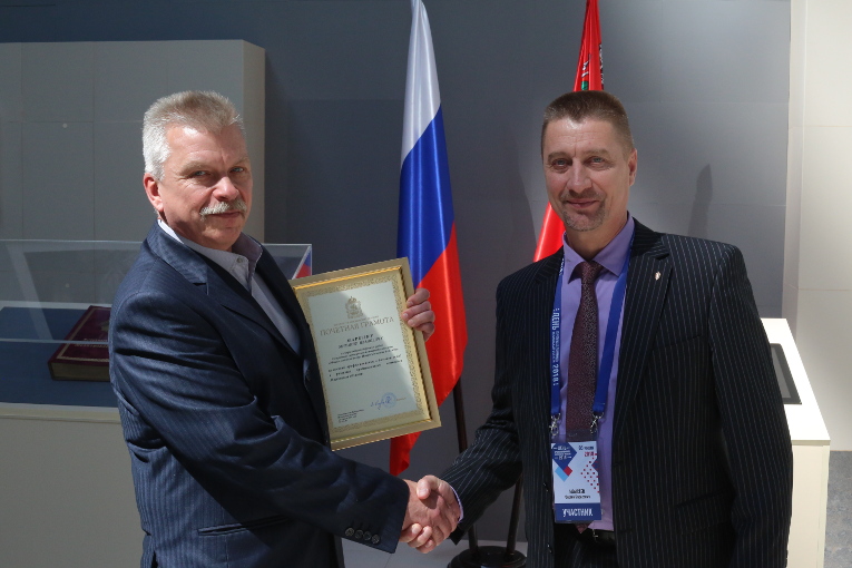 Mikhail Markin is receiving congratulations from Sergey Moisseev, General Director of Izolyator