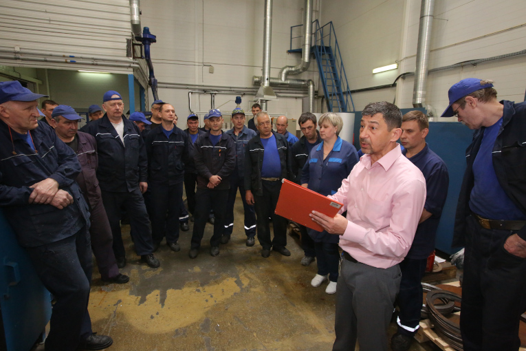 Boris Sobelman conducts instructions to the workers of the machine shop on how to act in case of fire
