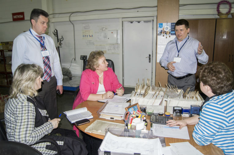 Elena Kostiova is auditing materials and completing parts procurement activities results at the warehouse of Izolyator plant