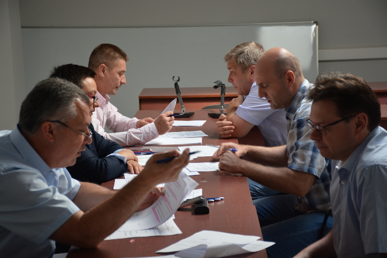 Alexander Slavinsky, Elena Posokh and Sergey Moisseev are administering an exam on accounting principles as professional training of Izolyator staff