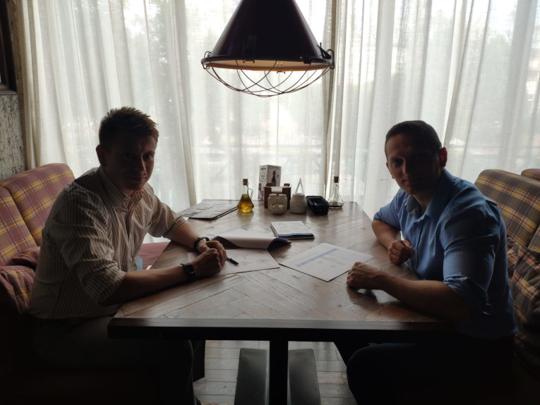 Alexander Znamenskiy (left) and Eltel Networks component purchasing manager Ireneusz Zawadski during negotiations at Eltel Networks in Poland