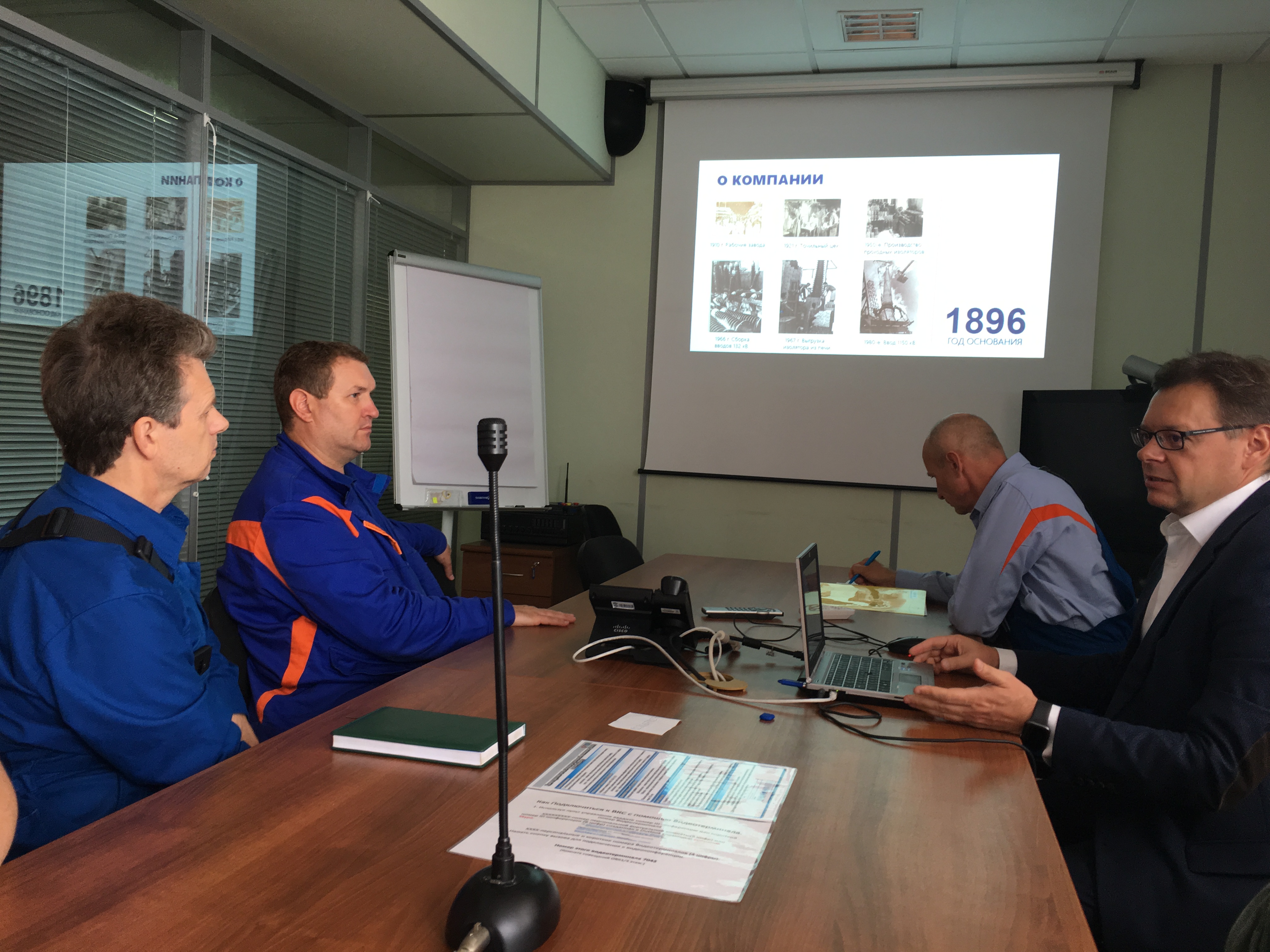 Oleg Bakulin (R) is giving a presentation about Izolyator at Konakovskaya SDPP
