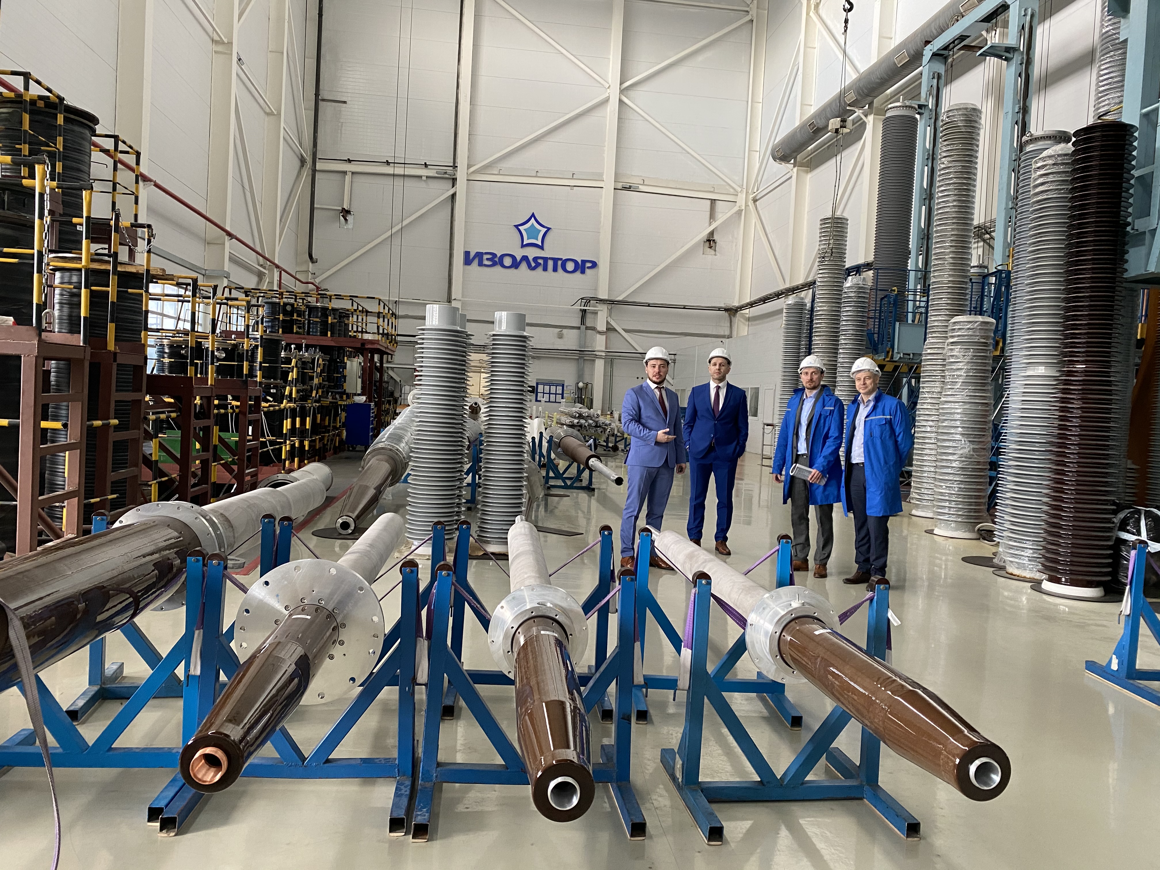 The top management of the Gefest Industrial Center metal trader are getting acquainted with the technology of assembly of high-voltage bushings at Izolyator plant